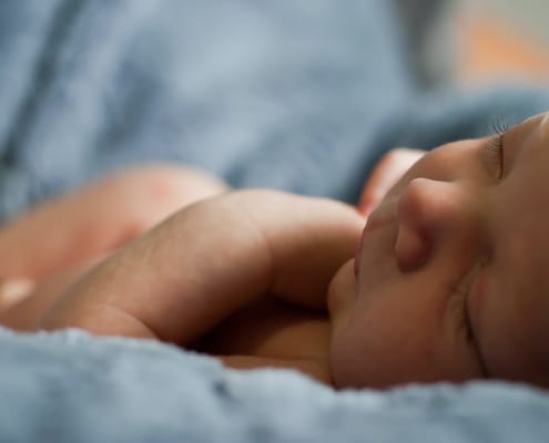Newborn child on soft blankets